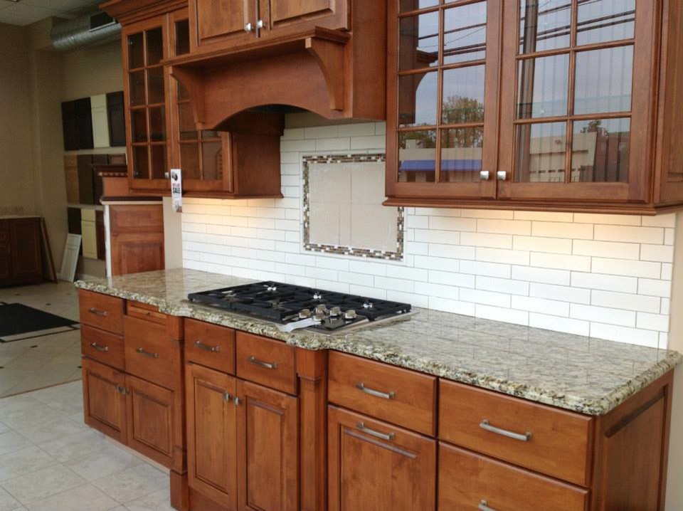 Inspiration for a mid-sized single-wall ceramic tile open concept kitchen remodel in Bridgeport with raised-panel cabinets, medium tone wood cabinets, granite countertops, white backsplash and subway tile backsplash