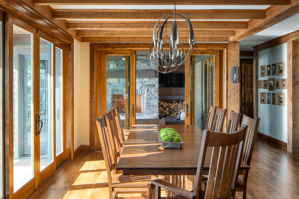 Country dining room in Minneapolis with white walls, medium hardwood floors and no fireplace.