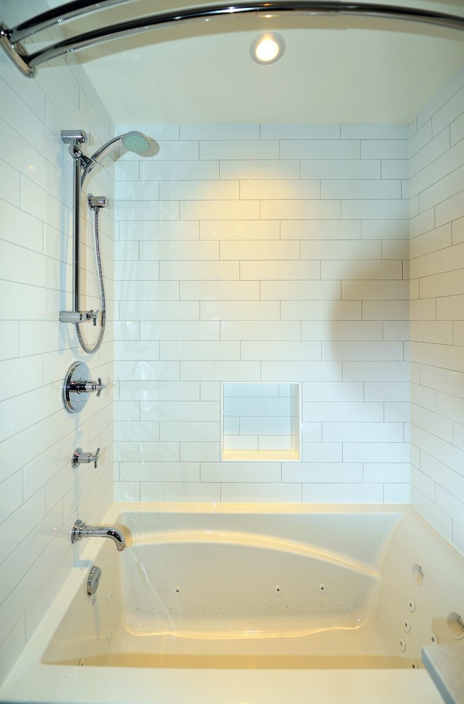 Alcove bathtub - mid-sized transitional 3/4 white tile and subway tile porcelain tile and black floor alcove bathtub idea in Ottawa with flat-panel cabinets, medium tone wood cabinets, a two-piece toilet, white walls, a drop-in sink, quartz countertops and white countertops