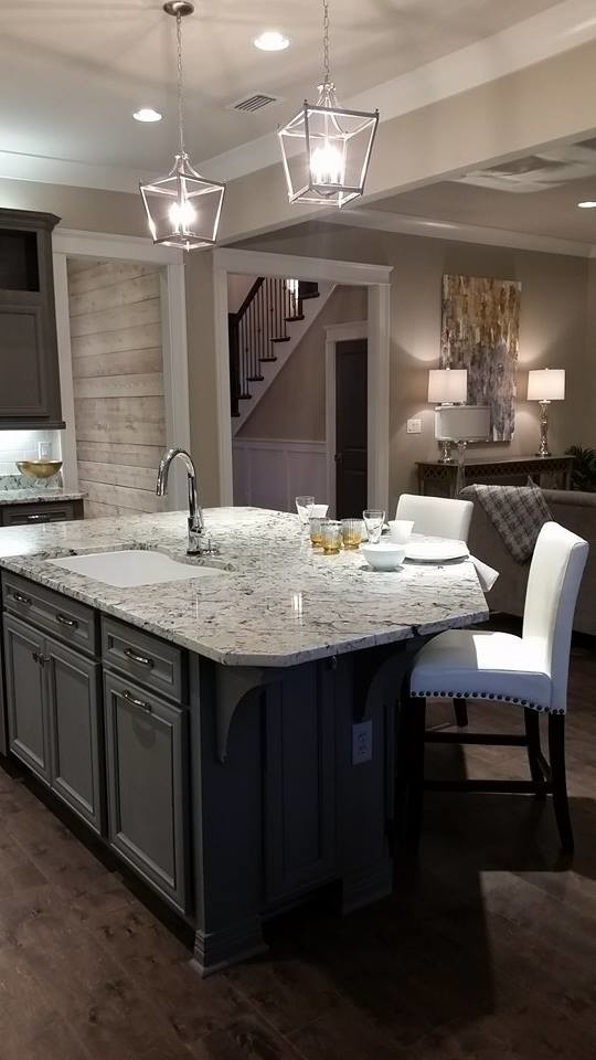 Photo of a large arts and crafts l-shaped eat-in kitchen in Miami with recessed-panel cabinets, grey cabinets, granite benchtops, white splashback, stainless steel appliances, dark hardwood floors and with island.