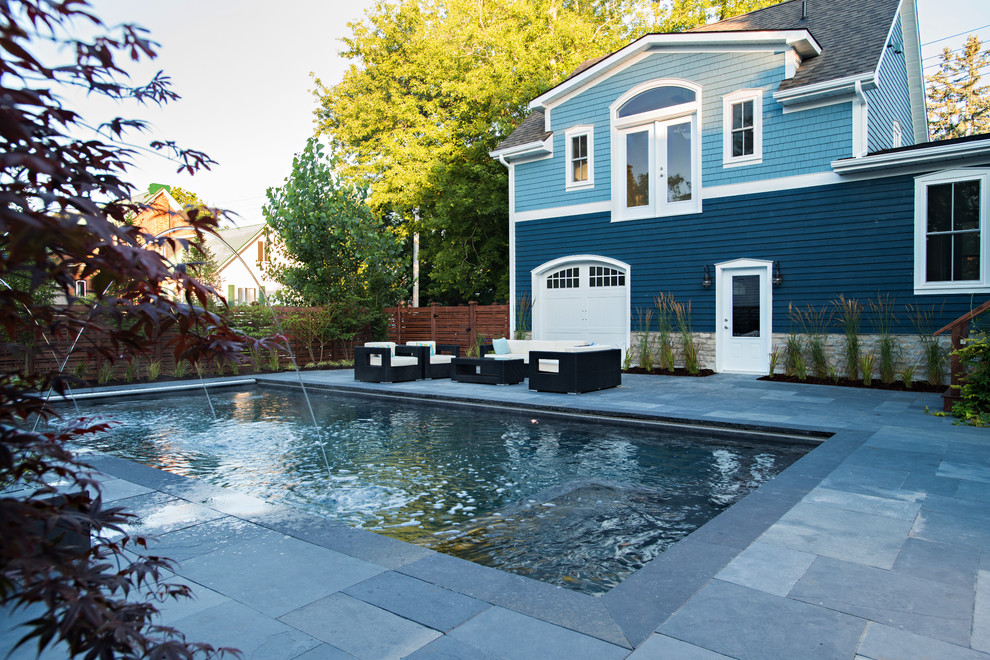 Pool fountain - transitional backyard concrete paver pool fountain idea in Toronto