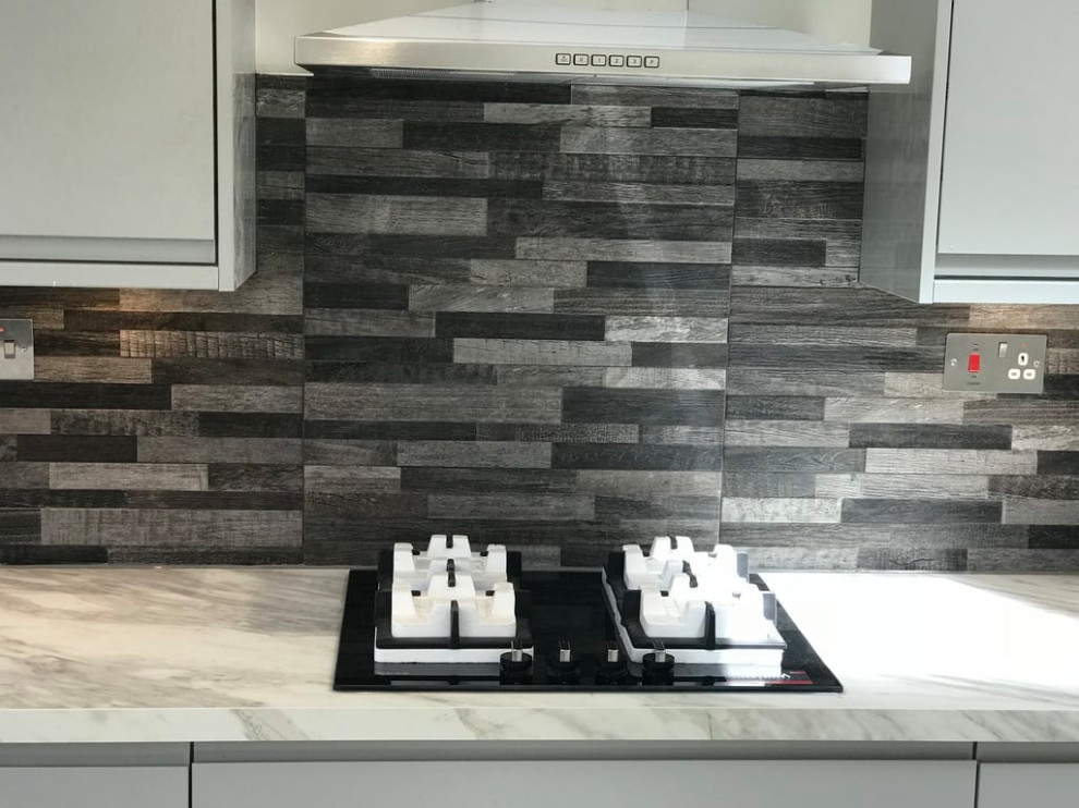 This is an example of a contemporary kitchen in Surrey.