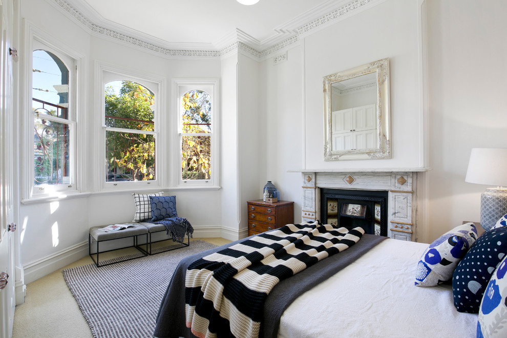 Transitional master bedroom in Sydney with white walls, carpet, a standard fireplace and beige floor.