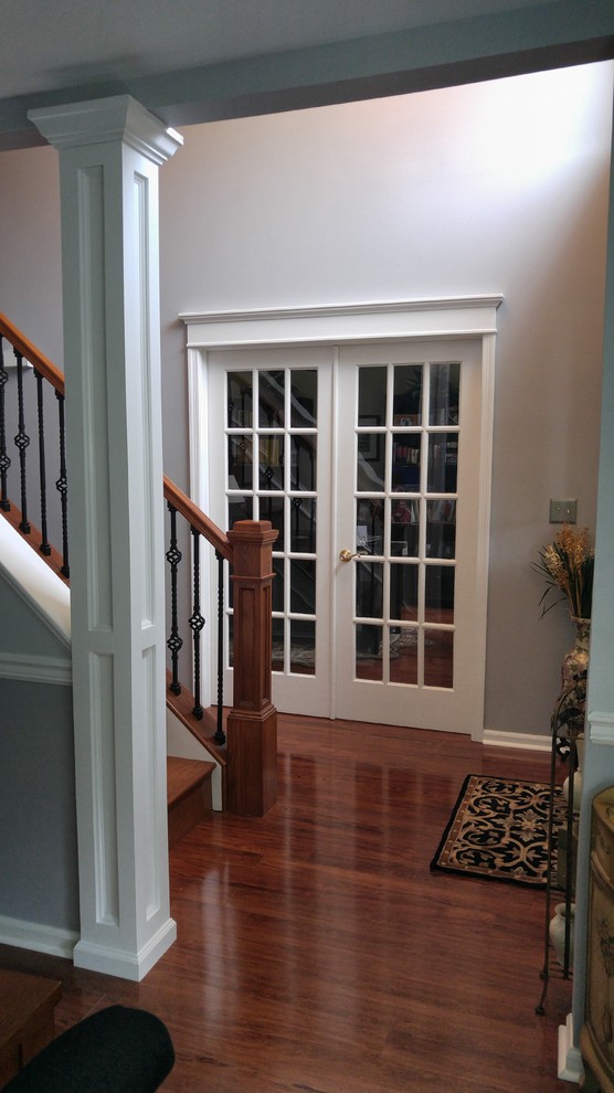 Mid-sized traditional wood straight staircase in Philadelphia with wood risers and wood railing.