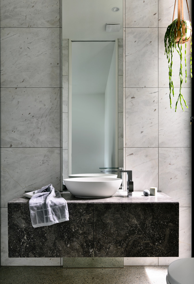 This is an example of a mid-sized contemporary 3/4 bathroom in Melbourne with flat-panel cabinets, grey cabinets, gray tile, terrazzo floors, a vessel sink, grey floor and grey benchtops.