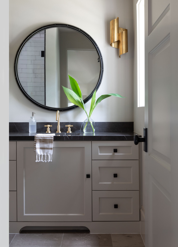 Photo of a mid-sized transitional 3/4 bathroom in Houston with recessed-panel cabinets, grey cabinets, an undermount sink, marble benchtops, black benchtops, a single vanity and a built-in vanity.
