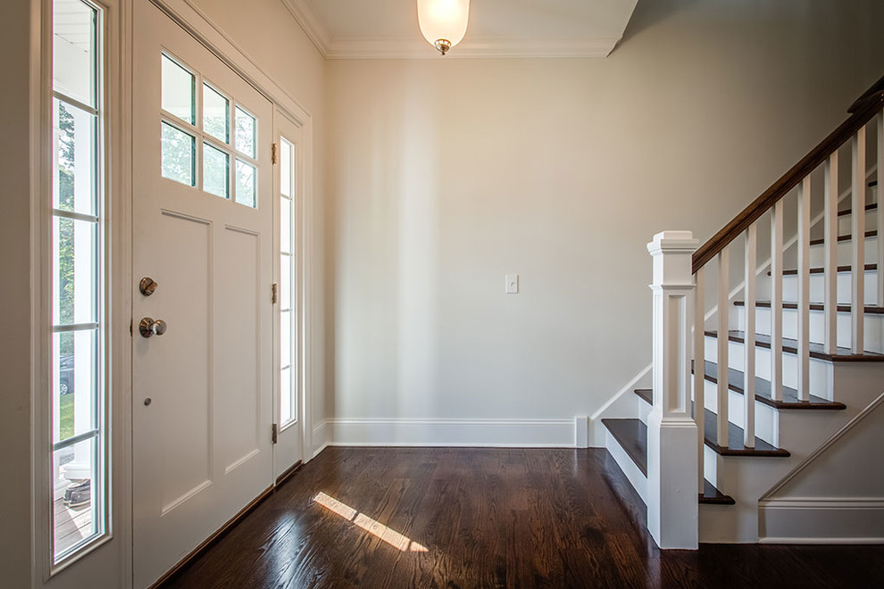 Inspiration for a mid-sized transitional dark wood floor and brown floor foyer remodel with white walls and a white front door