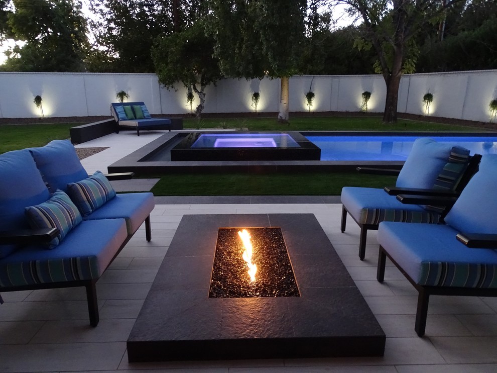 Design ideas for a large modern backyard rectangular lap pool in Phoenix with tile.