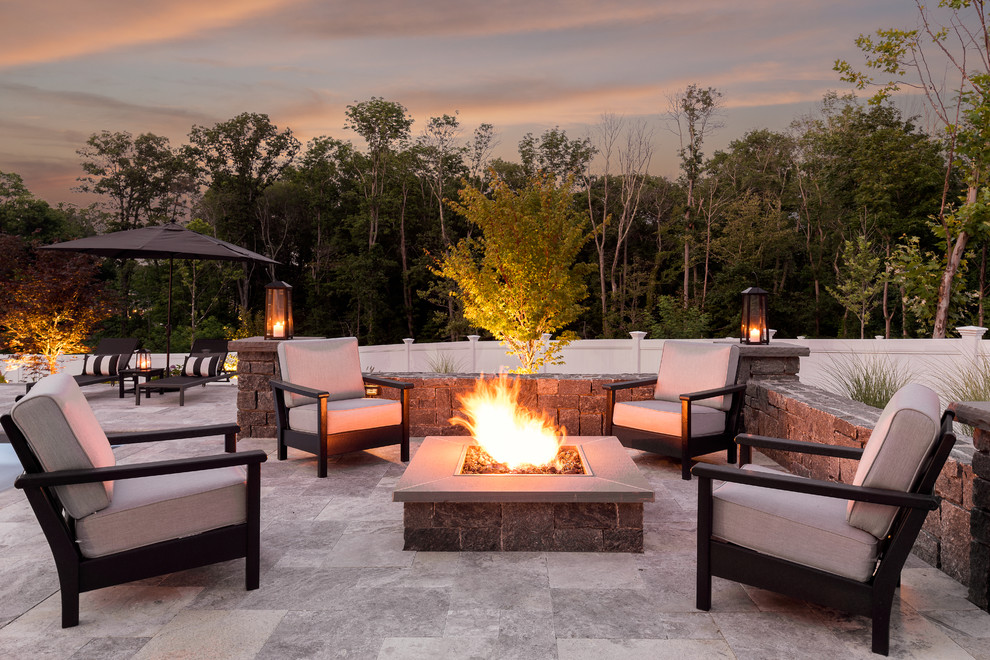 Photo of a mid-sized transitional backyard patio in Boston with a fire feature, no cover and natural stone pavers.
