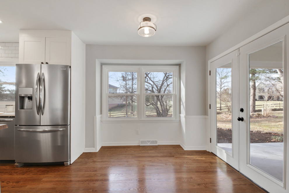 Mid-sized country kitchen/dining combo in Kansas City with grey walls and medium hardwood floors.