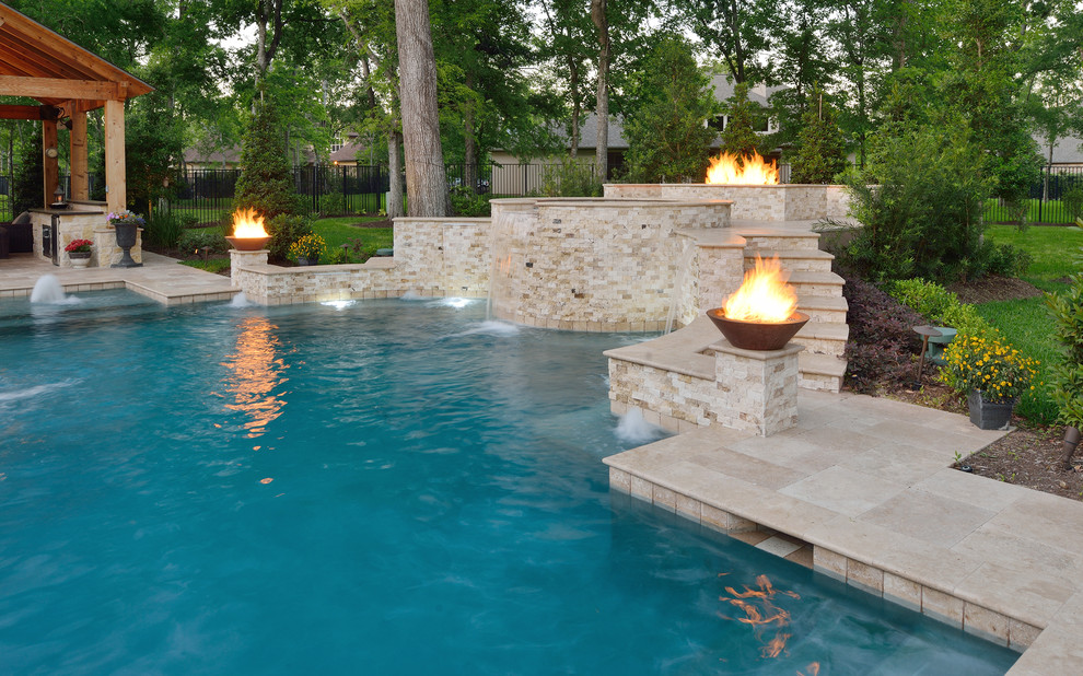 Design ideas for an expansive transitional backyard custom-shaped natural pool in Houston with natural stone pavers and a hot tub.