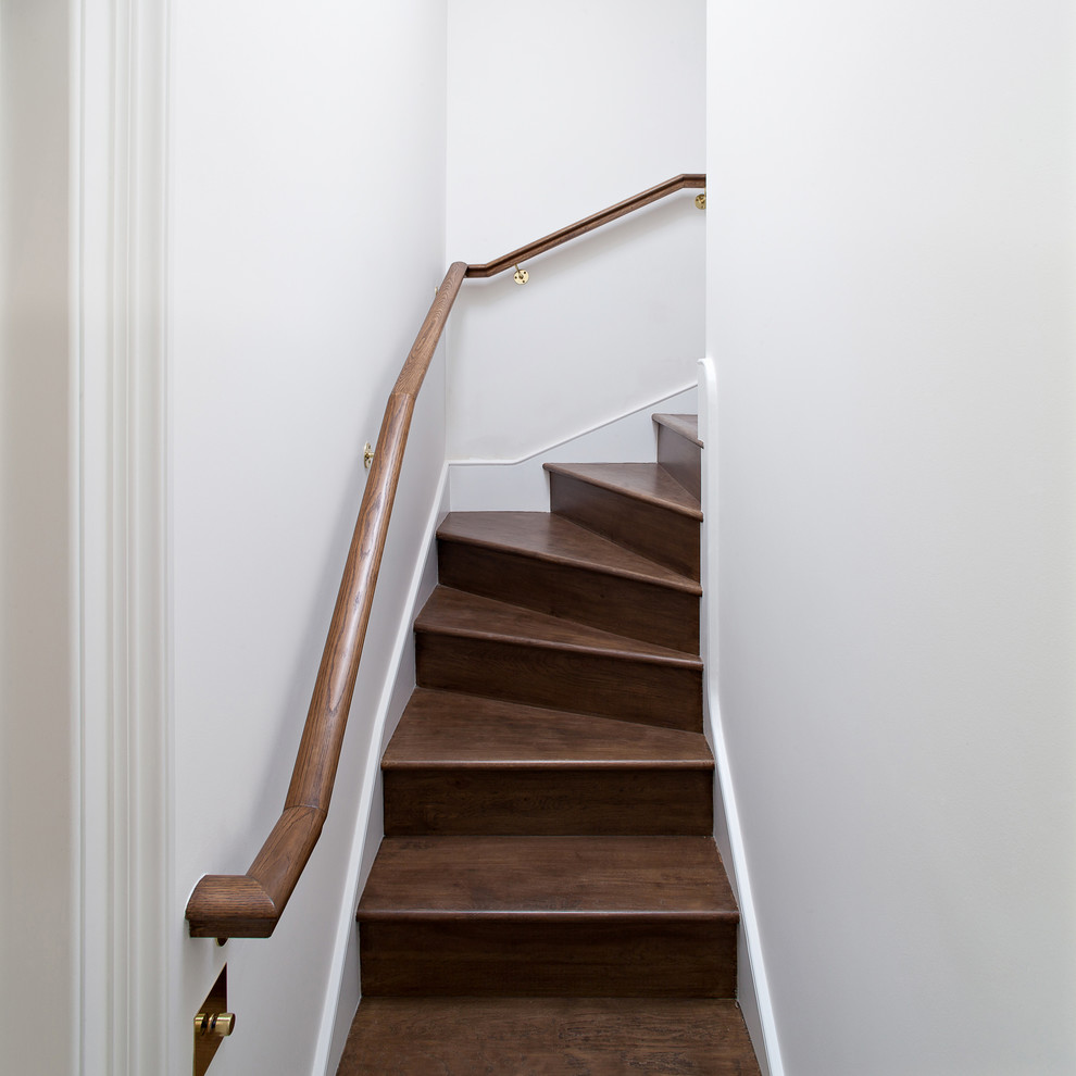 Design ideas for a mid-sized traditional wood l-shaped staircase in London with wood risers.