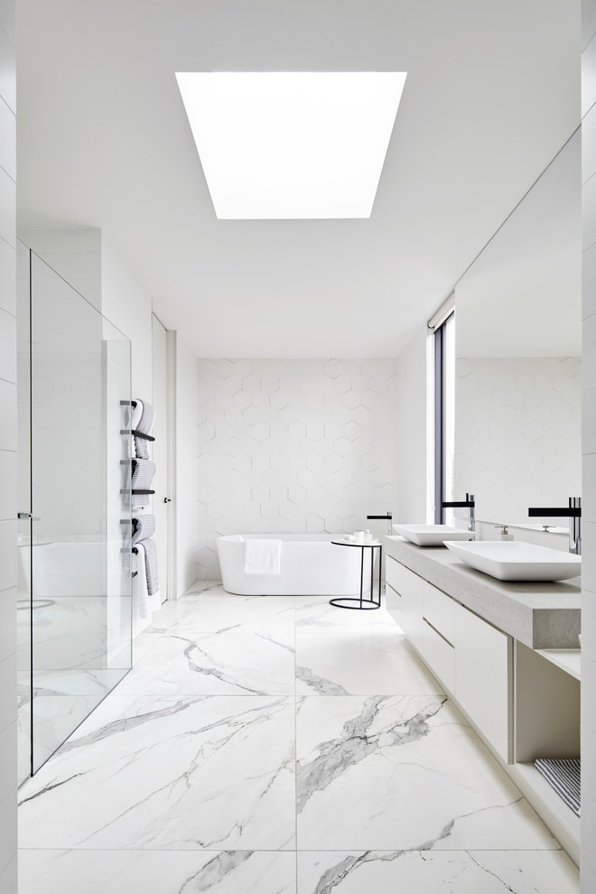 Inspiration for a mid-sized modern master bathroom in Melbourne with flat-panel cabinets, white cabinets, a freestanding tub, an alcove shower, white walls, marble floors and a hinged shower door.