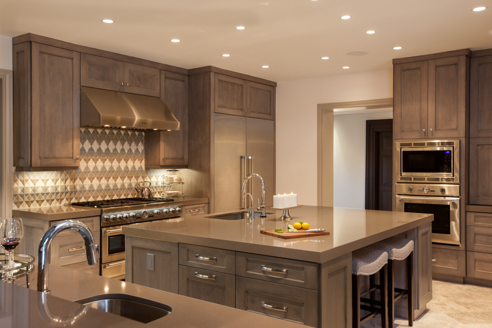 Large transitional eat-in kitchen photo in Houston with a double-bowl sink, recessed-panel cabinets, medium tone wood cabinets, granite countertops, multicolored backsplash, stainless steel appliances and an island