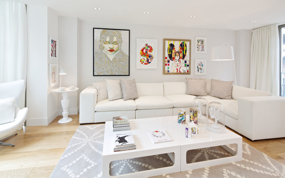 Photo of a contemporary living room in London with white walls and light hardwood floors.