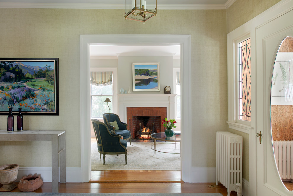 This is an example of a mid-sized traditional foyer in Boston with beige walls, medium hardwood floors, a single front door and a white front door.