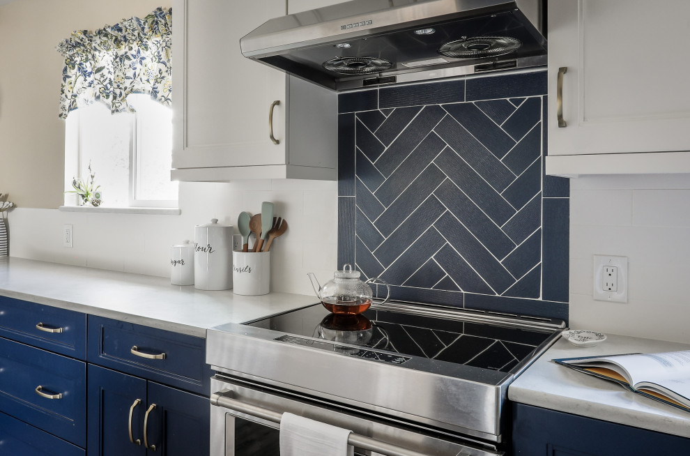 Example of a mid-sized transitional galley vinyl floor and brown floor eat-in kitchen design in Denver with shaker cabinets, blue cabinets, quartz countertops, no island, white backsplash, ceramic backsplash, stainless steel appliances and white countertops