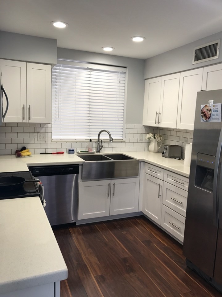 Inspiration for a small traditional galley eat-in kitchen in Phoenix with a farmhouse sink, shaker cabinets, white cabinets, quartzite benchtops, white splashback, subway tile splashback, stainless steel appliances and no island.
