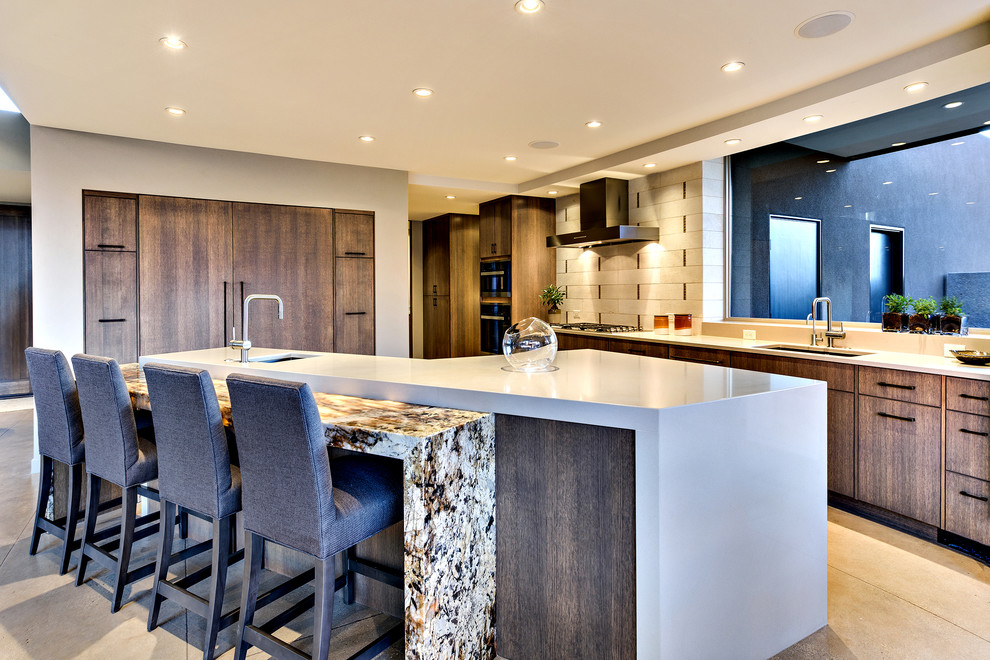 Design ideas for a mid-sized modern l-shaped open plan kitchen in Salt Lake City with an undermount sink, flat-panel cabinets, medium wood cabinets, solid surface benchtops, window splashback, stainless steel appliances, concrete floors and with island.