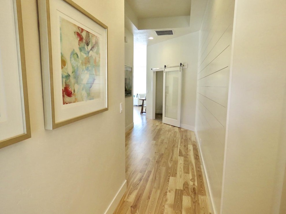 Inspiration for a small transitional entry hall in Boise with white walls and light hardwood floors.