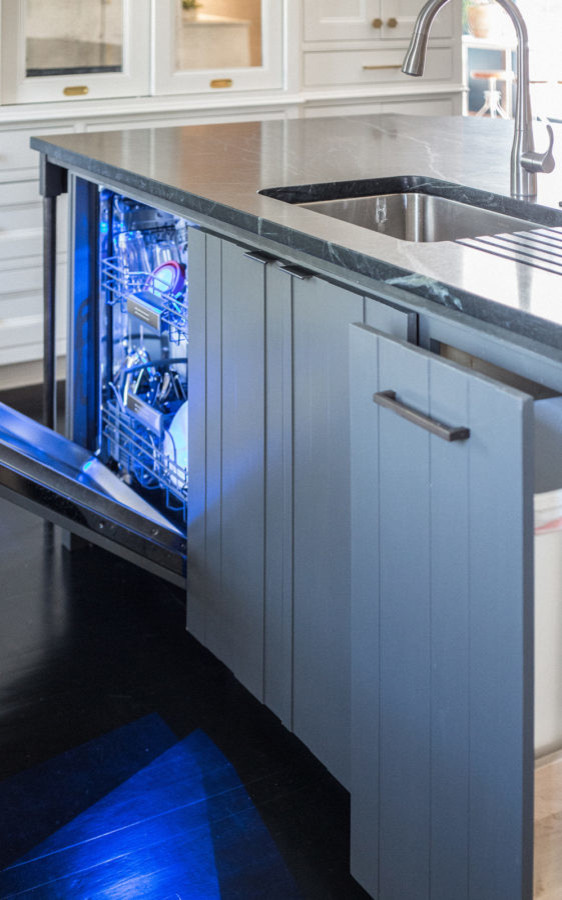 Large transitional u-shaped dark wood floor enclosed kitchen photo with an undermount sink, recessed-panel cabinets, white cabinets, granite countertops, white backsplash, stainless steel appliances and an island