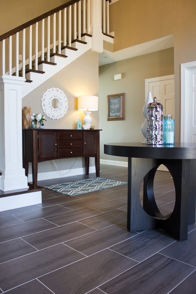 Inspiration for a large transitional porcelain tile foyer remodel in Cedar Rapids with beige walls and a white front door