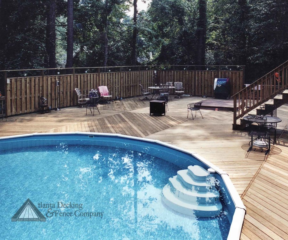 Example of a transitional backyard deck design in Atlanta