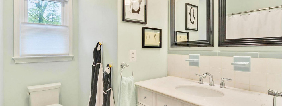 Photo of a small bohemian family bathroom in DC Metro with shaker cabinets, white cabinets, a one-piece toilet, green tiles, ceramic tiles, green walls, ceramic flooring, a submerged sink, quartz worktops, multi-coloured floors, a shower curtain, white worktops, double sinks and a freestanding vanity unit.