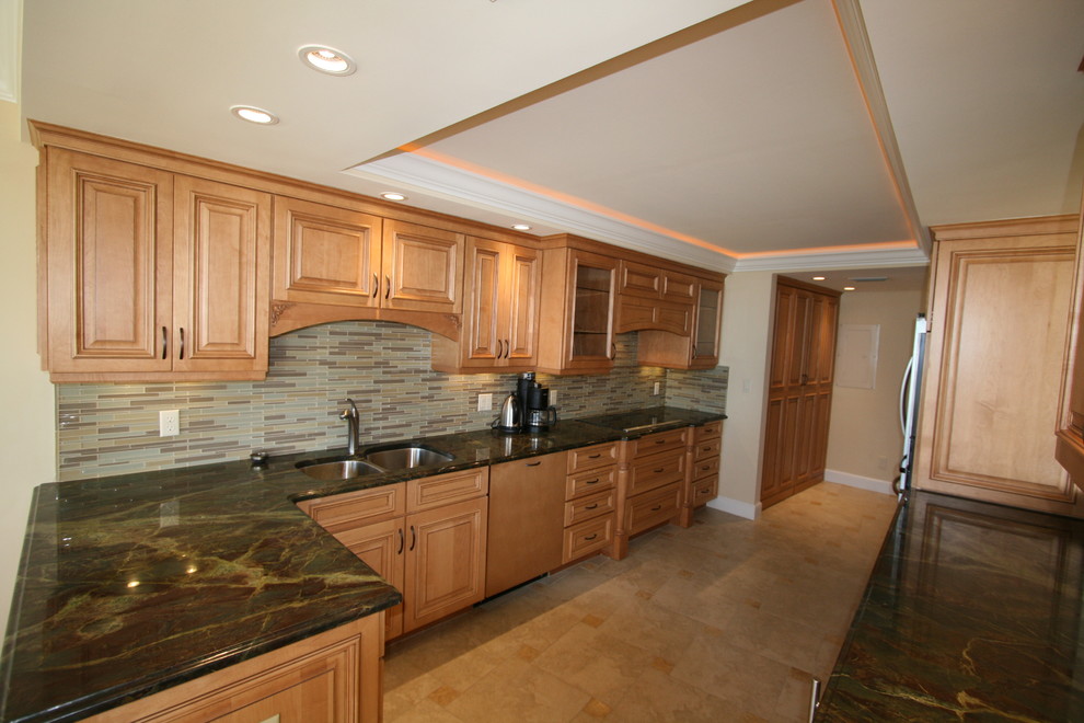Large transitional galley medium tone wood floor eat-in kitchen photo in Miami with an undermount sink, raised-panel cabinets, medium tone wood cabinets, marble countertops, multicolored backsplash, matchstick tile backsplash, stainless steel appliances and a peninsula