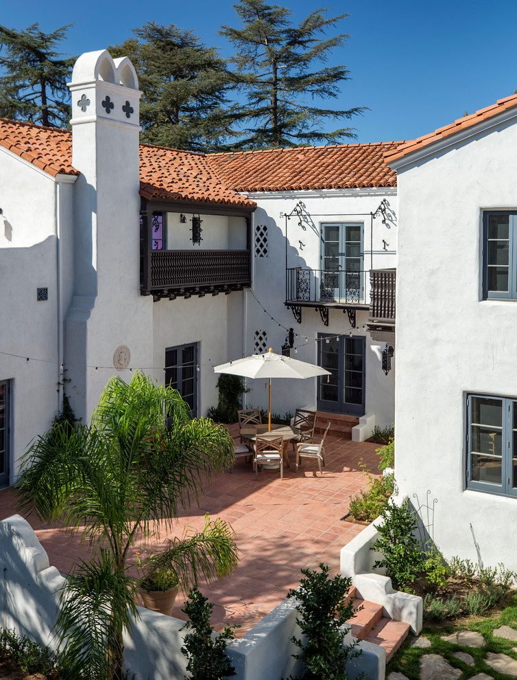 This is an example of an expansive mediterranean two-storey stucco white exterior in Los Angeles.