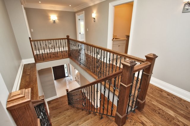 Inspiration for a mid-sized transitional wood straight staircase in Toronto with wood risers.