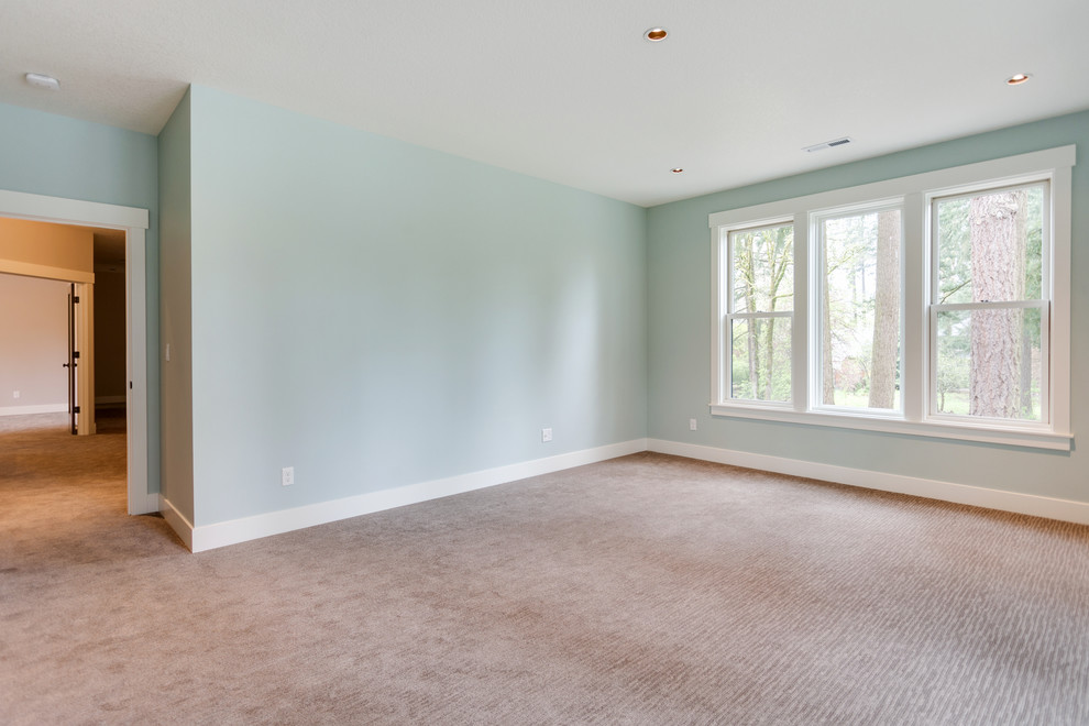 Photo of a mid-sized country master bedroom in Salt Lake City with blue walls, carpet, no fireplace and beige floor.