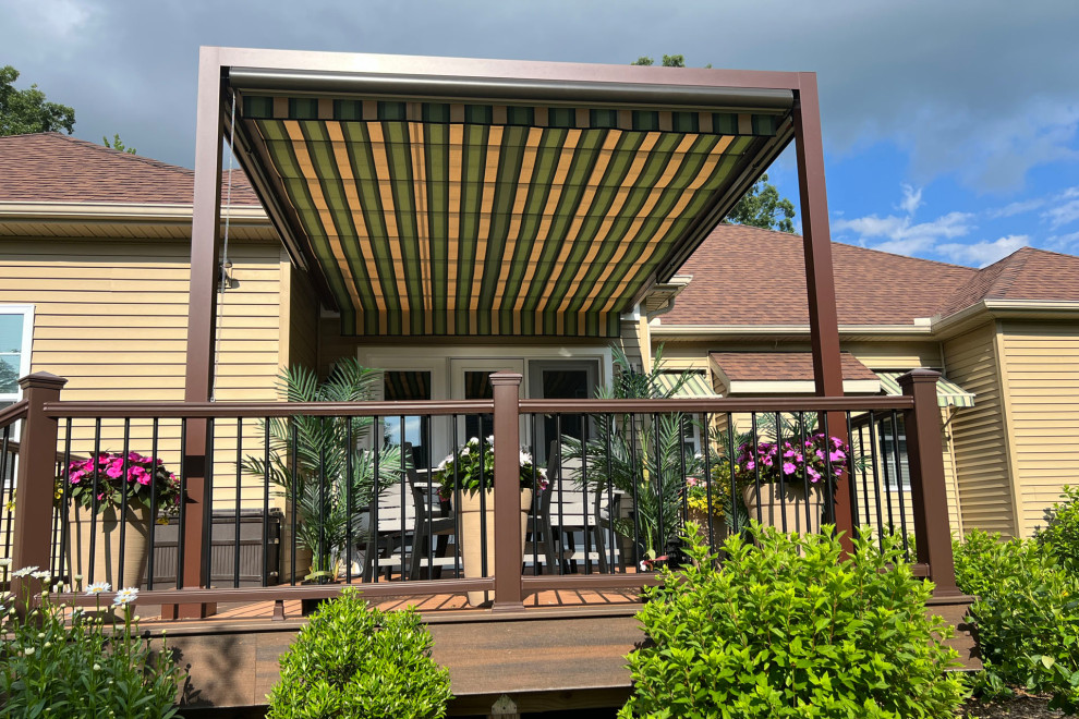 This is an example of a traditional back ground level mixed railing terrace in Boston with a pergola.