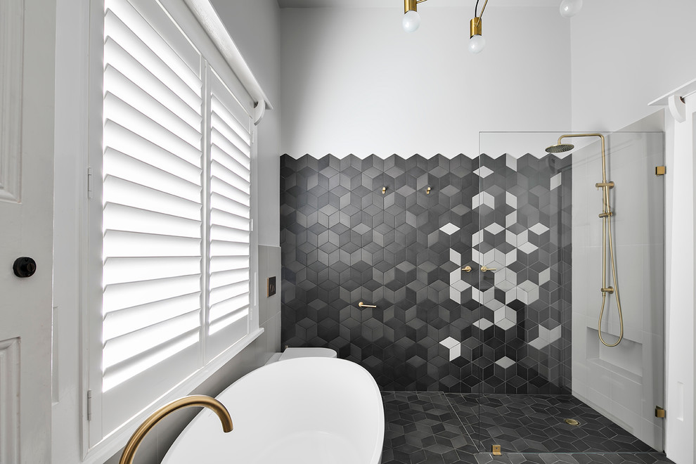 Inspiration for a contemporary master bathroom in Adelaide with furniture-like cabinets, dark wood cabinets, a freestanding tub, an open shower, multi-coloured tile, cement tile and grey walls.
