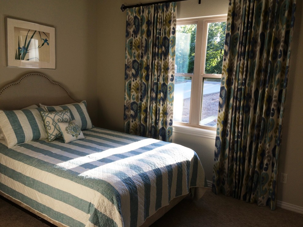 This is an example of a small transitional guest bedroom in Other with beige walls and carpet.