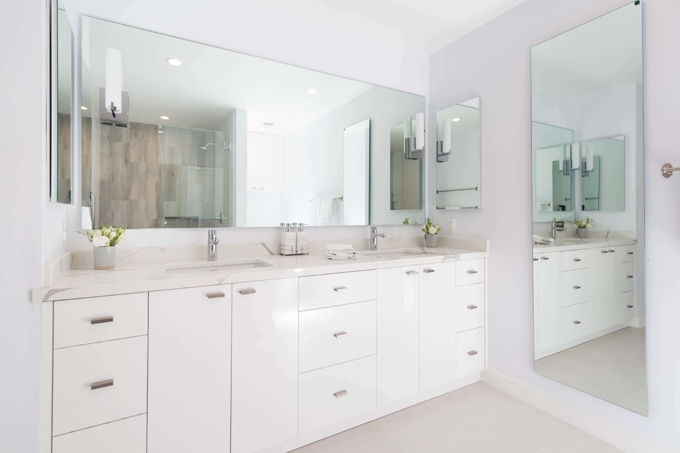 Inspiration for a large modern master bathroom in Los Angeles with flat-panel cabinets, white cabinets, white walls, porcelain floors, an undermount sink, engineered quartz benchtops, white floor and multi-coloured benchtops.