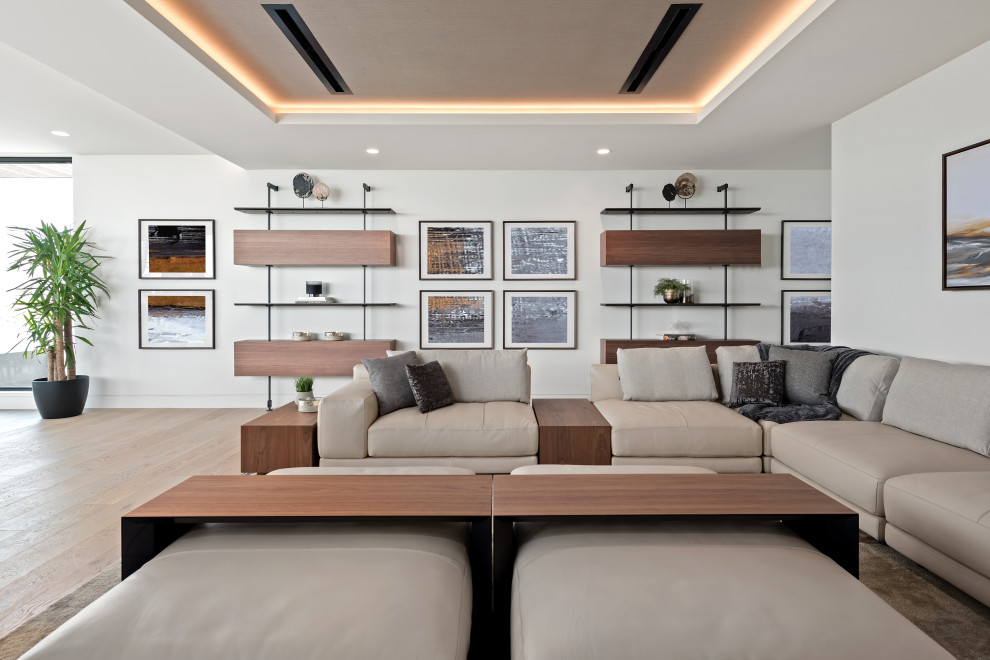 Example of a huge minimalist open concept family room design in Las Vegas with white walls and a media wall