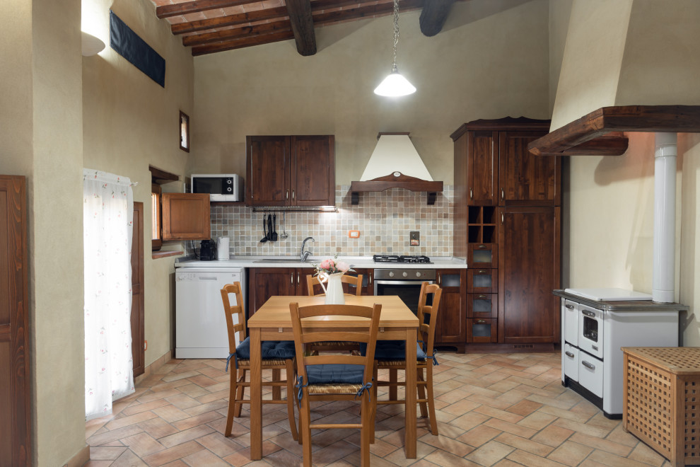 Inspiration for a small country single-wall eat-in kitchen in Florence with a drop-in sink, recessed-panel cabinets, medium wood cabinets, laminate benchtops, multi-coloured splashback, mosaic tile splashback, white appliances, ceramic floors, pink floor, white benchtop and exposed beam.