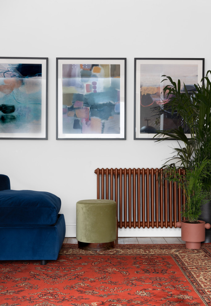 マンチェスターにあるお手頃価格の広いミッドセンチュリースタイルのおしゃれなLDK (白い壁、淡色無垢フローリング、薪ストーブ、木材の暖炉まわり、壁掛け型テレビ、レンガ壁) の写真