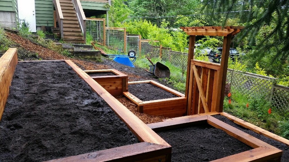 Photo of a mid-sized arts and crafts sloped full sun garden for summer in Other with a vegetable garden and mulch.