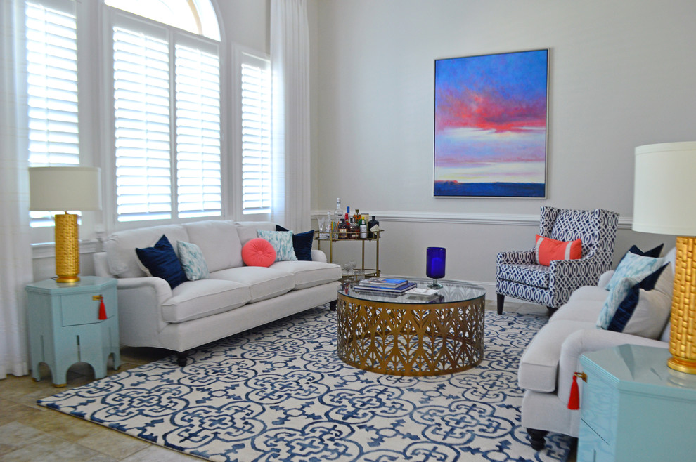 Photo of a mid-sized beach style open concept living room in Orlando with beige walls, ceramic floors, no fireplace, no tv and beige floor.
