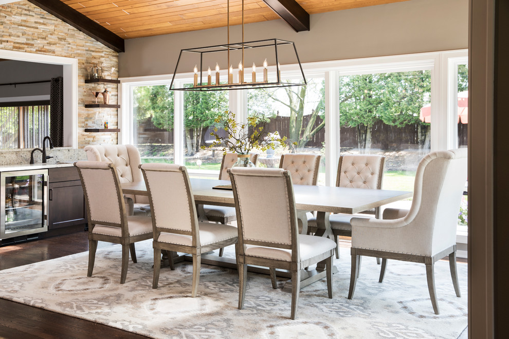 Example of a large transitional dark wood floor and brown floor dining room design