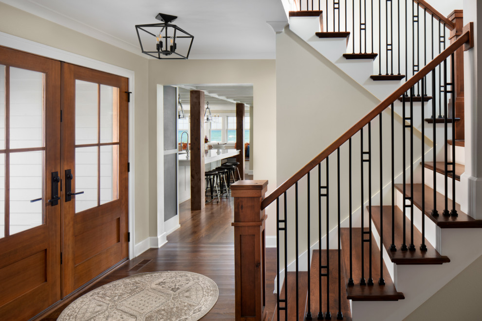 This is an example of a classic entrance in Milwaukee with beige walls, dark hardwood flooring, a double front door, a dark wood front door and brown floors.