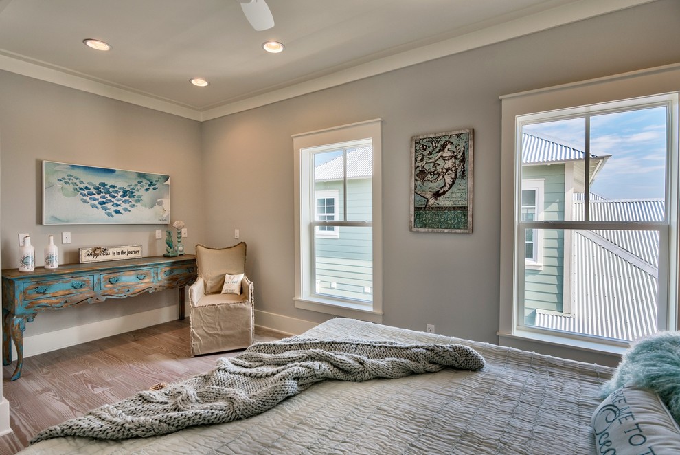 This is an example of a mid-sized traditional bedroom in Miami with grey walls, light hardwood floors and no fireplace.