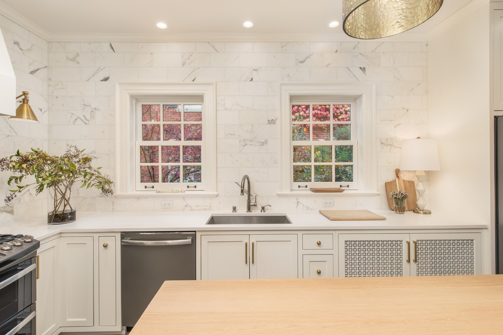 Kitchen - transitional kitchen idea in Milwaukee with quartz countertops and marble backsplash