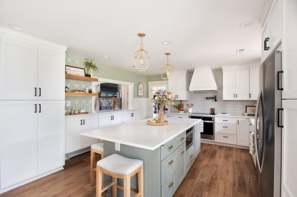 Mid-sized transitional u-shaped medium tone wood floor and brown floor eat-in kitchen photo in Baltimore with a farmhouse sink, shaker cabinets, green cabinets, quartz countertops, green backsplash, ceramic backsplash, stainless steel appliances, an island and white countertops