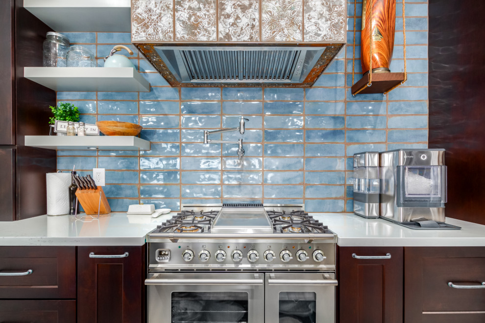 Expansive country l-shaped eat-in kitchen in Phoenix with a farmhouse sink, shaker cabinets, dark wood cabinets, quartz benchtops, blue splashback, subway tile splashback, with island and white benchtop.