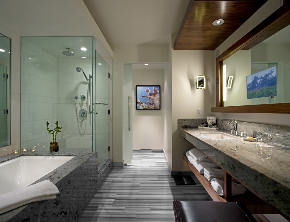 This is an example of a large contemporary master bathroom in Vancouver with open cabinets, dark wood cabinets, an undermount tub, a corner shower, white tile, a two-piece toilet, porcelain tile, white walls, an undermount sink and granite benchtops.