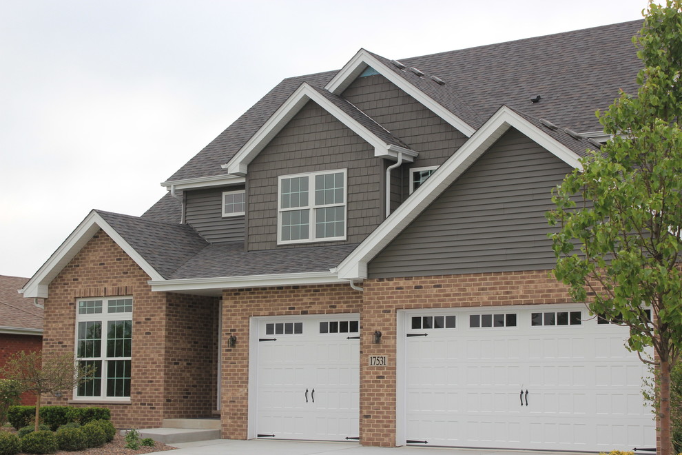 Inspiration for a medium sized and gey traditional two floor detached house in Chicago with wood cladding, a pitched roof and a shingle roof.