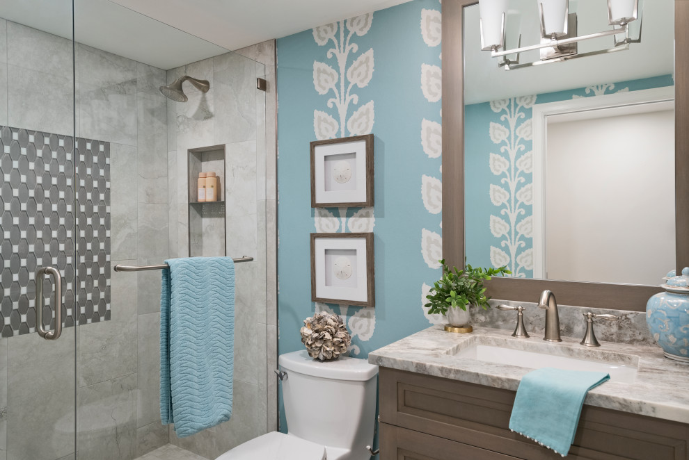 Design ideas for a coastal cloakroom in Other with recessed-panel cabinets, brown cabinets, grey tiles, blue walls, a submerged sink, granite worktops, multi-coloured worktops, a freestanding vanity unit and wallpapered walls.